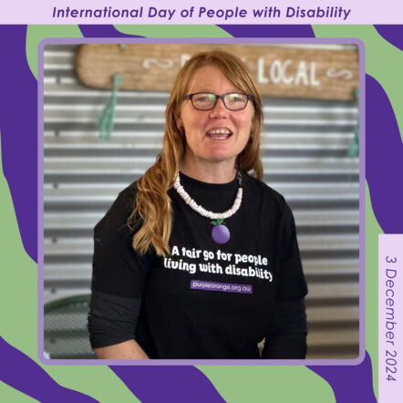 Dark purple and light green background with a square frame containing photo of Regional Connector, Liluella. She is wearing a black Purple Orange t-shirt, glasses and a white shell necklace. She has long red hair. Small text around border reads: International Day of People with Disability. 3 December 2024.